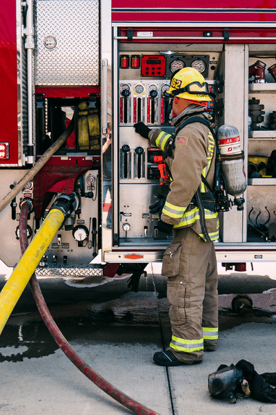 Firefighter Standing Next to Truck